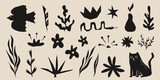 Set of abstract organic shapes in cut boho style - hand drawn vector illustrations of plants and animals in black. Doodle style leaves, flowers, bird and cat silhouette. Cute botanical design assets.