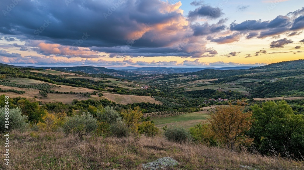A scenic vista of rolling hills and cloudy evening skies A scenic vista of rolling hills and cloudy evening skies