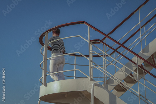 Obraz na płótnie Woman day dreaming on luxurious transatlantic crossing aboard the luxury ocean liner cruise ship Queen Mary with views of the ocean and seascape until horizon with sunset w salonie