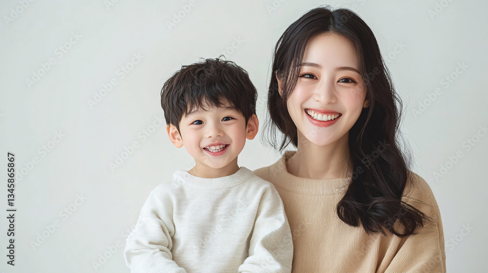 Studio Portrait of a Happy Asian Mother and Daughter: A Family Concept Featuring a Japanese Young Mother and Her Cute Son Interacting and Smiling in Front of a Plain White Background Studio Portrait of a Happy Asian Mother and Daughter: A Family Concept Featuring a Japanese Young Mother and Her Cute Son Interacting and Smiling in Front of a Plain White Background