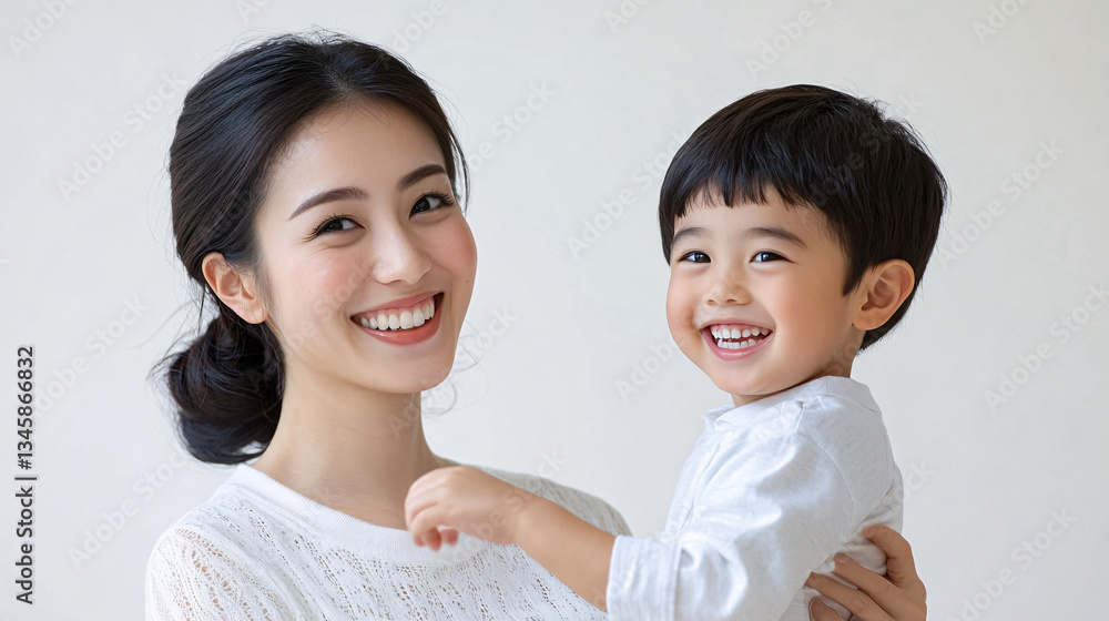 Studio Portrait of a Happy Asian Mother and Daughter: A Family Concept Featuring a Japanese Young Mother and Her Cute Son Interacting and Smiling in Front of a Plain White Background Studio Portrait of a Happy Asian Mother and Daughter: A Family Concept Featuring a Japanese Young Mother and Her Cute Son Interacting and Smiling in Front of a Plain White Background