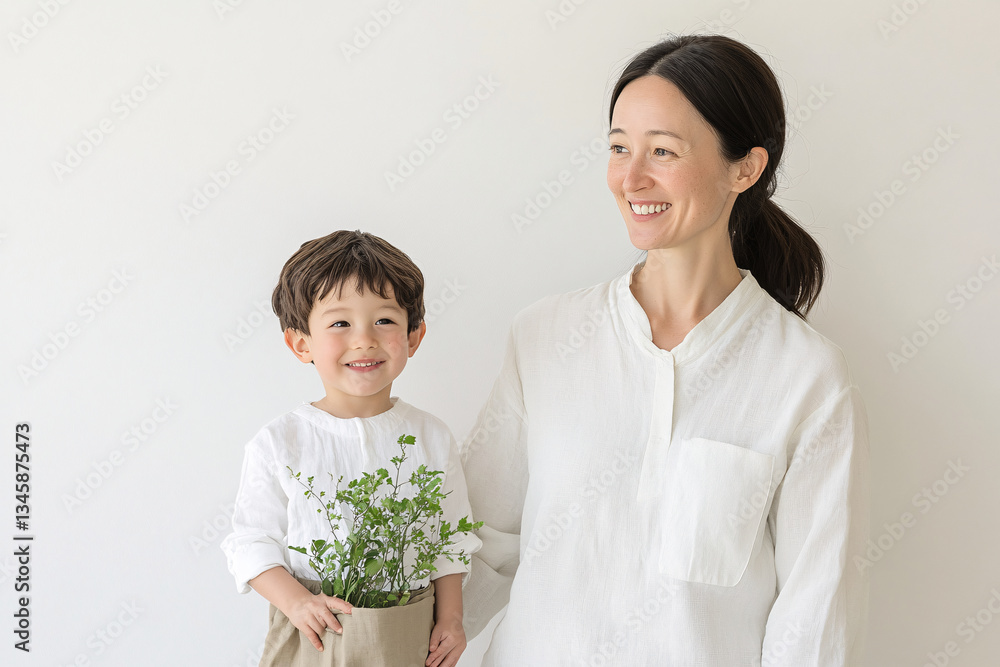 Studio Portrait of a Happy Asian Mother and Daughter: A Family Concept Featuring a Japanese Young Mother and Cute Son Interacting and Smiling in Front of a Plain White Background Studio Portrait of a Happy Asian Mother and Daughter: A Family Concept Featuring a Japanese Young Mother and Cute Son Interacting and Smiling in Front of a Plain White Background