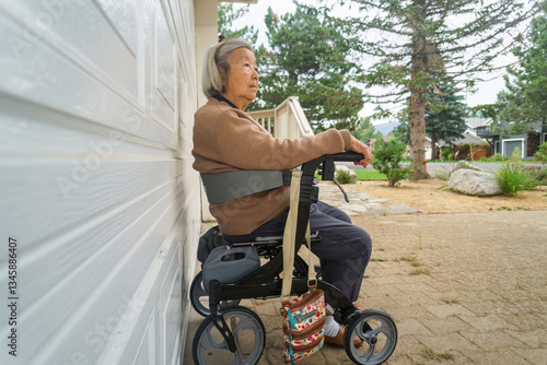 Obraz na płótnie Elderly woman resting on a mobility walker outside the house. California, USA. w salonie