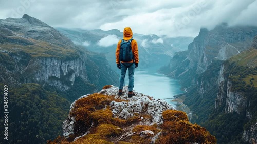 hiker on top of mountain, showing success while clmbing a mountain 