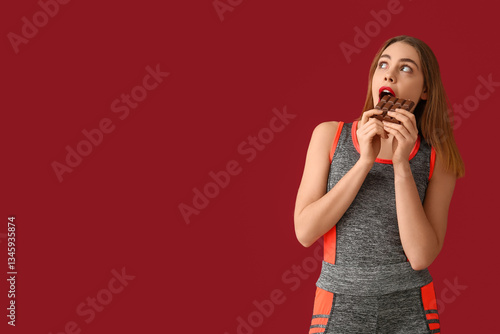 Young woman eating sweet ch...