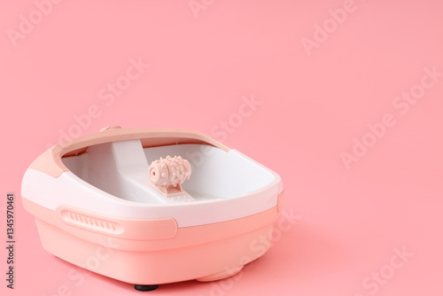 Massage foot bath on pink b...