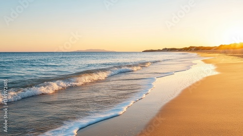 Wallpaper Mural A serene beach at sunset with gentle waves lapping against golden sand, creating a peaceful coastal atmosphere. Torontodigital.ca