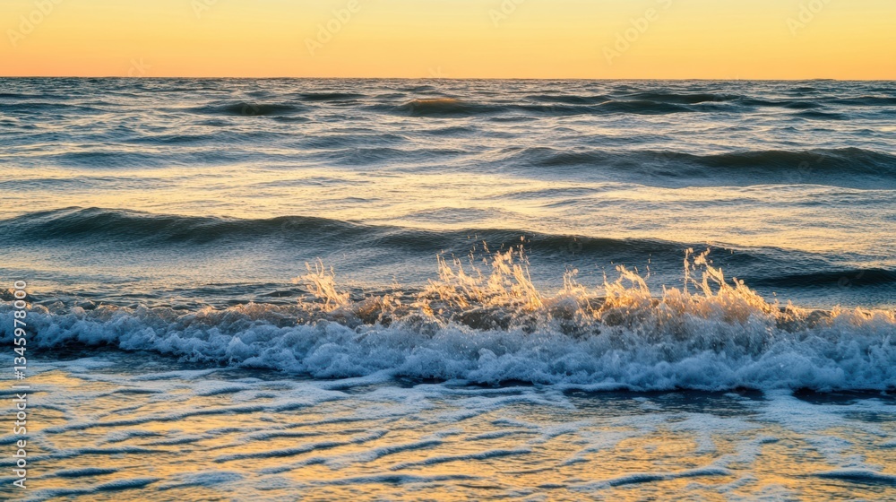 Naklejka premium A serene ocean view at sunset, with gentle waves reflecting golden hues on the water's surface.