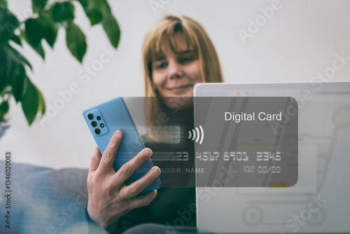 Woman makes online purchase using a digital card on laptop. Convenience and ease of e-commerce. Secure web shopping, digital payments and modern retail technology. E-commerce, digital transactions.