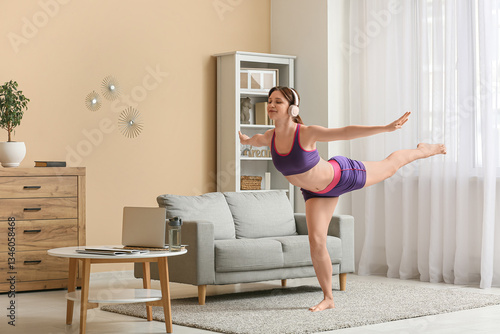 Young woman practicing yoga...