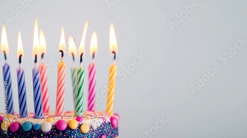 Decorative birthday candles placed on white background with copy space