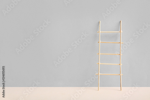 Wooden ladder on grey backg...