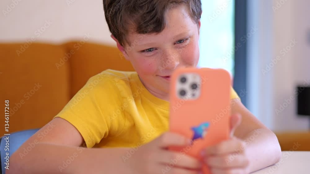 Joyful eight-year-old creating memories at home with a smartphone Joyful eight-year-old creating memories at home with a smartphone
