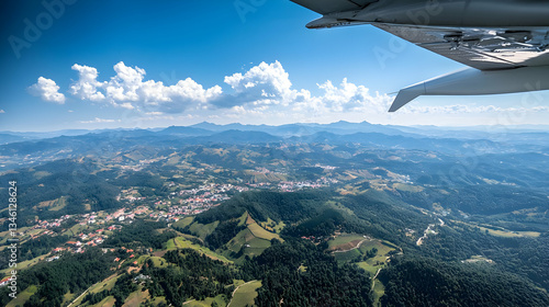 Aerial View Of Lush Green Valley And Cityscape With Blue Sky