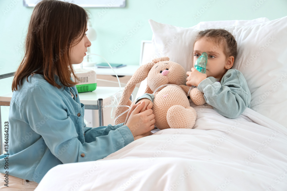 Obraz premium Woman and her ill little daughter with nebulizer in clinic