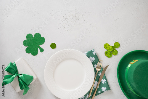 Obraz na płótnie St Patrick's Day banner with white plate, cutlery, table setting, gift, leprechaun hat and clover leaves on white background. View from above. Copy space. w salonie