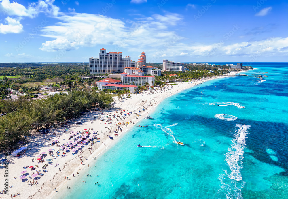 Aerial view of the public beach at Goodmans Bay, Nassau, Bahamas, with water sports action and turquoise ocean