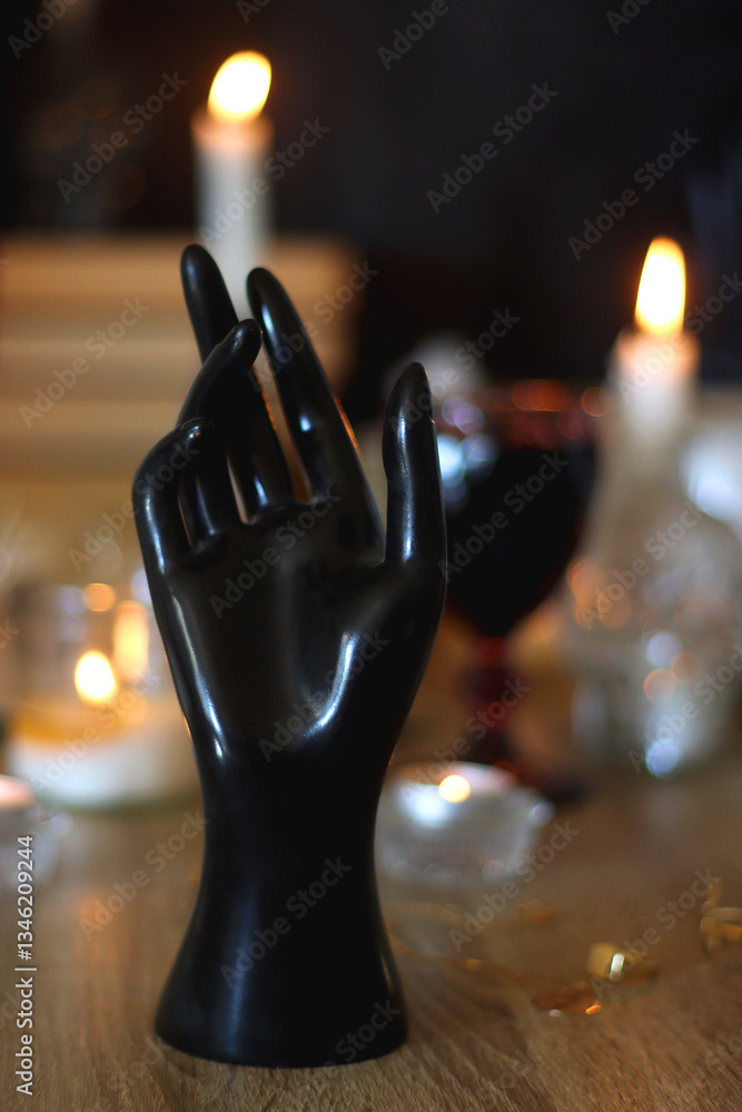 Books, lit candles, red wine, snacks and various deocration on the table. Dark academia or Halloween concept. Selective focus.