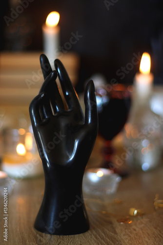 Books, lit candles, red wine, snacks and various deocration on the table. Dark academia or Halloween concept. Selective focus.