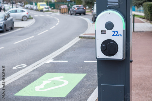 Electric car charging at plug in charging station. Renewable clean energy car for eco awareness lifestyle concept. City street power hub providing eco-friendly sustainable supply for EV vehicle