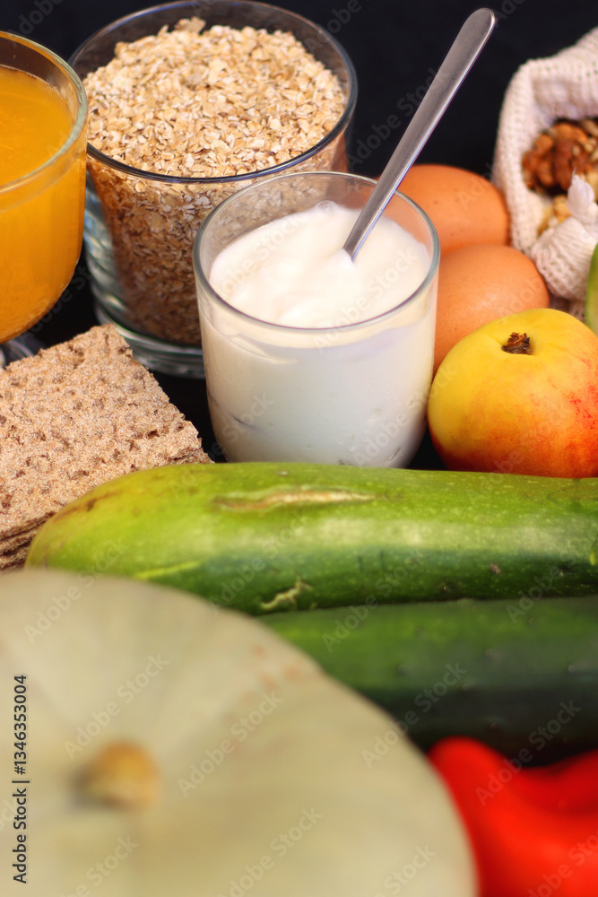 Various healthy fruits, vegetables and cereals on dark background. Selective focus.