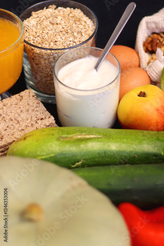 Various healthy fruits, vegetables and cereals on dark background. Selective focus.