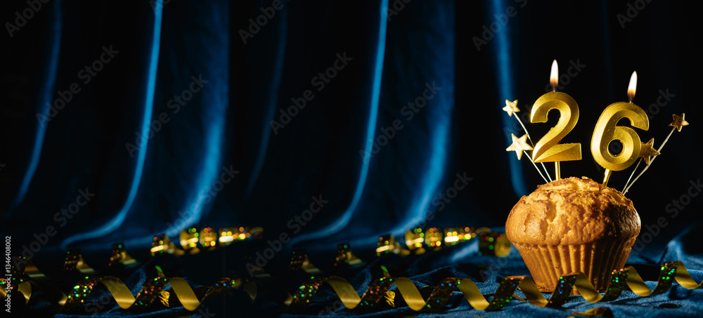 Fototapeta premium Coming age party 26th birthday. chocolate cupcake with number twenty-six candle on velvet blue background. Banner