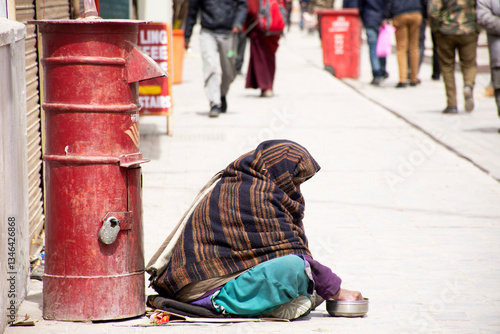 JAMMU KASHMIR, INDIA - MARCH 19 : Old indian women beggar or untouchables caste sitting and begging money from travelers people in market at Leh Ladakh Village on March 19, 2019 in New Delhi, India