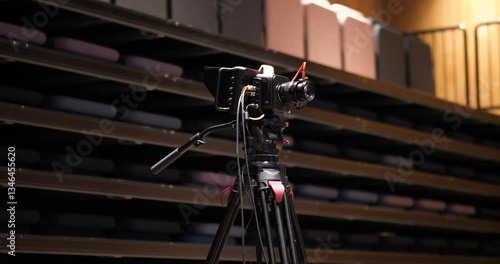 Professional cinema camera on a cinema tripod with gear connected ready to film
