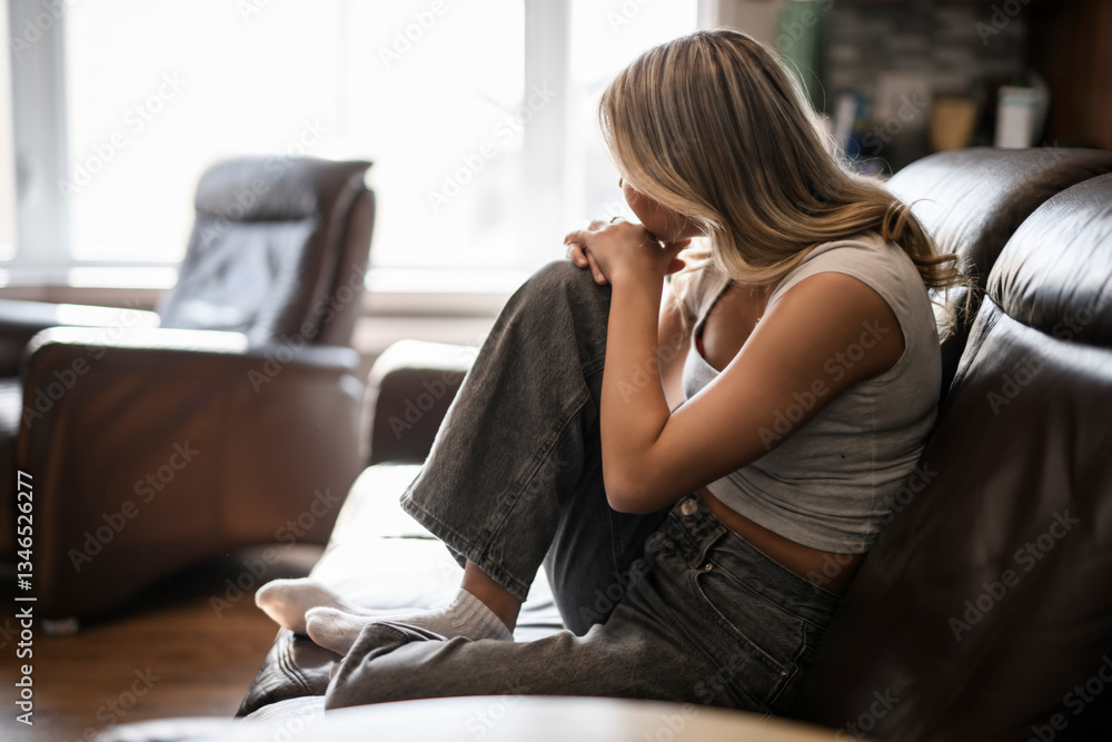 Obraz premium sad and stress teen sit on sofa at home