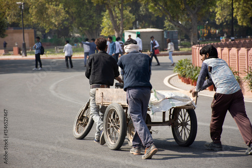 Indian and foreign people worker bike bicycle and use tricycle carrying and delivery product on the road of rural at Delhi city in New Delhi, India