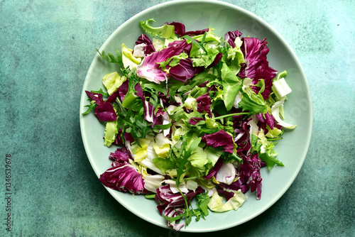 Mix of fresh salad leaves on a plate. Top view with copy space.