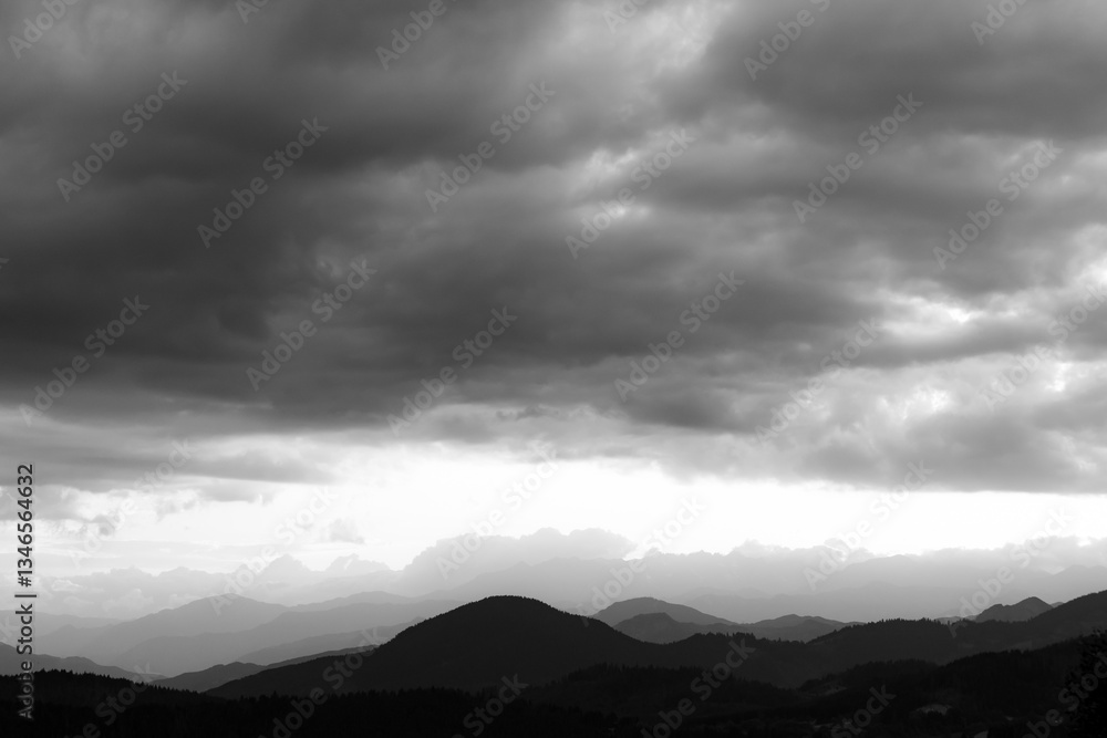 Landscape of the mountain range with cloudy sky in black and white shot Landscape of the mountain range with cloudy sky in black and white shot