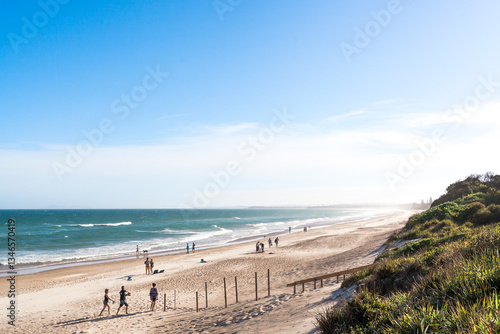 A variety of people and families enjoy a summers day holiday at long beach