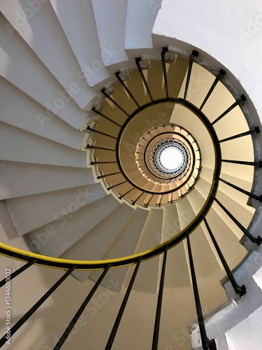 Fotografie View looking up a spiraling staircase, highlighting its circular and symmetrical design