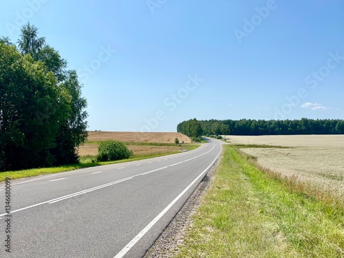 Scenic Highway Through Rural Countryside on Sunny Day