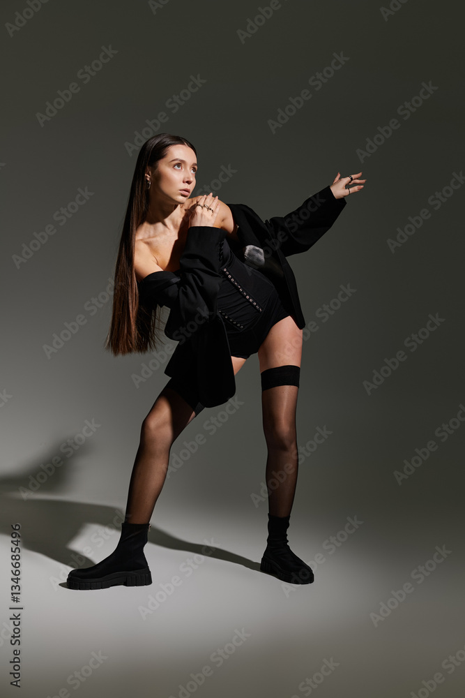 Obraz premium Stylish young gymnast showcasing her flexibility and athleticism in a modern artistic setting