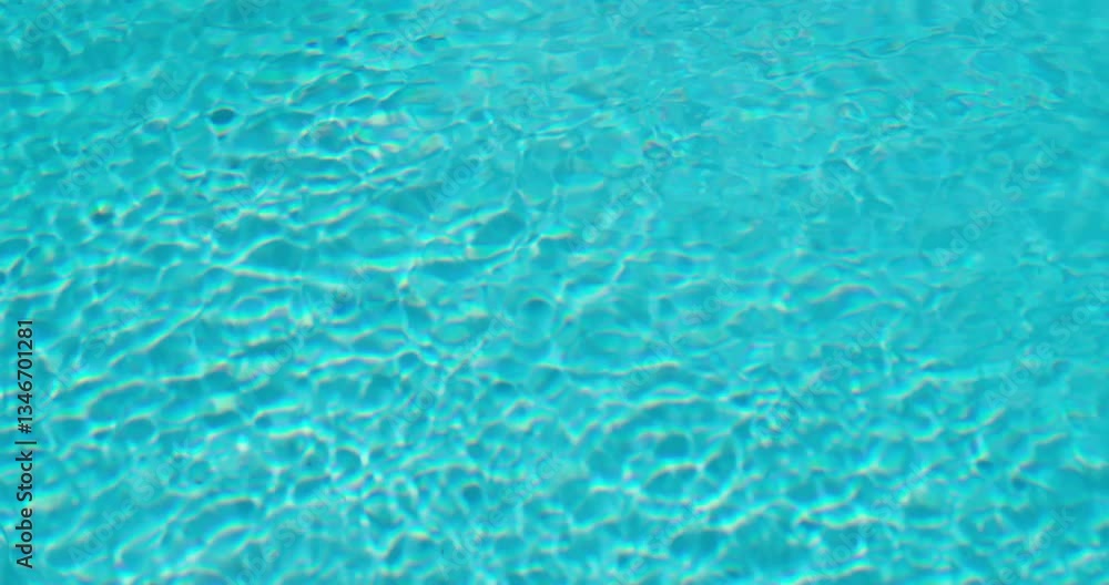 Vibrant blue pool water with intricate ripple patterns and shimmering reflections, perfect for backgrounds and design textures. Vibrant blue pool water with intricate ripple patterns and shimmering reflections, perfect for backgrounds and design textures.