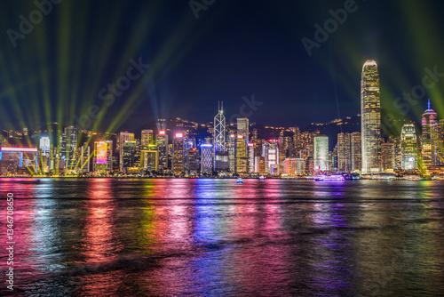 Canvas Print The night view Hong Kong skyline at night with lights and skyscrapers over sea with laser beams, lights show