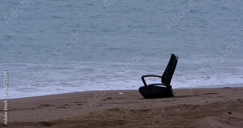 a deserted beach and an old chair
