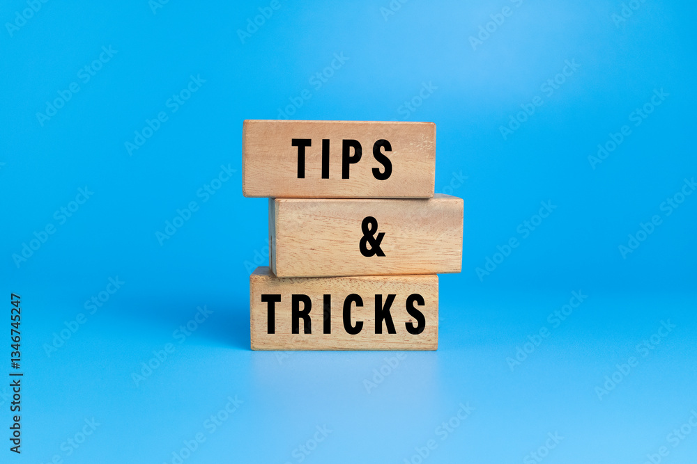 tips and tricks words on wooden blocks isolated on blue background tips and tricks words on wooden blocks isolated on blue background