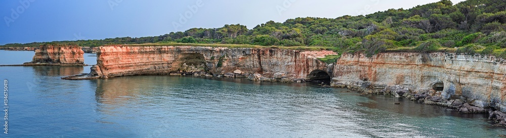 Fototapeta premium Panoramic view of Salento coastline, Puglia, Italy. Rocky cliffs, clear waters, and lush vegetation. Captures the natural beauty of the Adriatic coast...