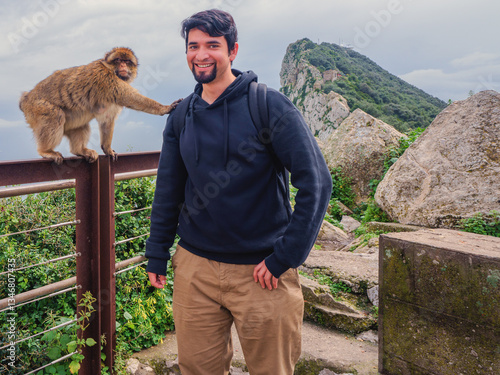 Barbary Macaque monkey reaching out a hand of friendship to a visitor on Gibraltar rock.