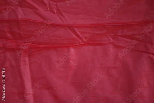 Crimson Fabric Texture: A captivating view of richly textured crimson fabric, showcasing subtle folds and patterns, offering a sense of depth and visual interest.