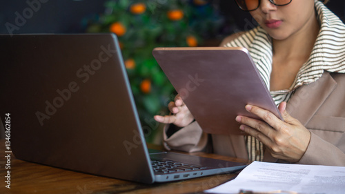 Wallpaper Mural Businesswoman working diligently with technology devices in the office with tablet and laptop on the desk. Torontodigital.ca