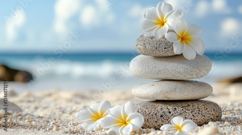 serene beach scene featuring stacked stones and delicate white flowers, promoting relaxation and wellness. gentle waves in background enhance tranquil atmosphere