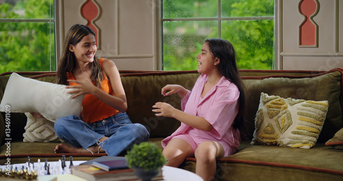 Εκτύπωση καμβά Indian happy gen z young adult two woman lady sitting cozy sofa couch enjoy day