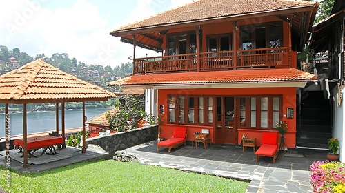 Elegant Red House with Scenic View by the Water and Lush Garden