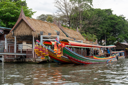 A khlong or river channel of Chao Phraya river with longtail wooden boats and residential buildings in Bangkok Thailand Asia 