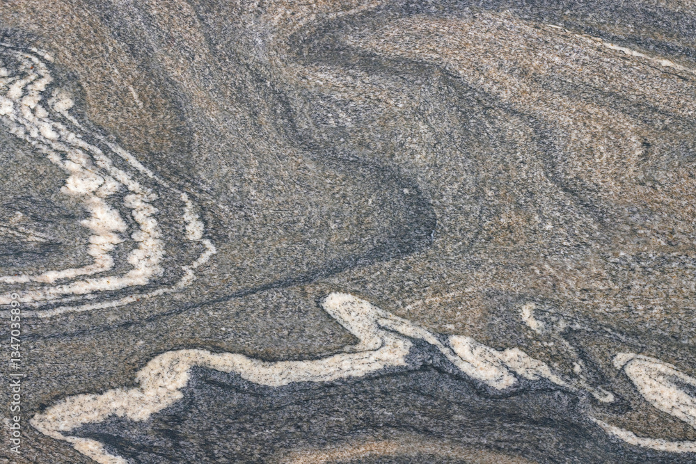 Swirling patterns of textured rock display nature's artistry in muted tones of gray and white